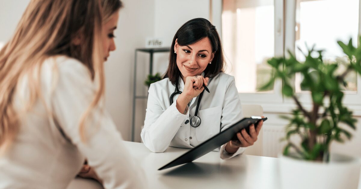 Functional medicine provider reviewing lab results on a tablet with a patient