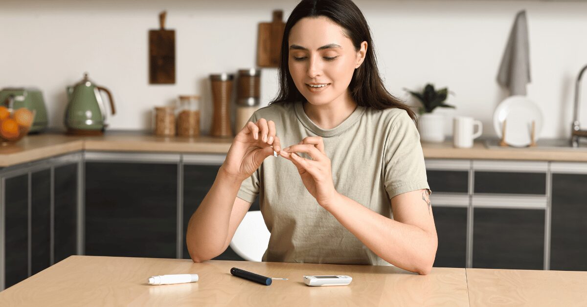 Woman checking her blood sugar with a finger-stick glucose meter at her kitchen table