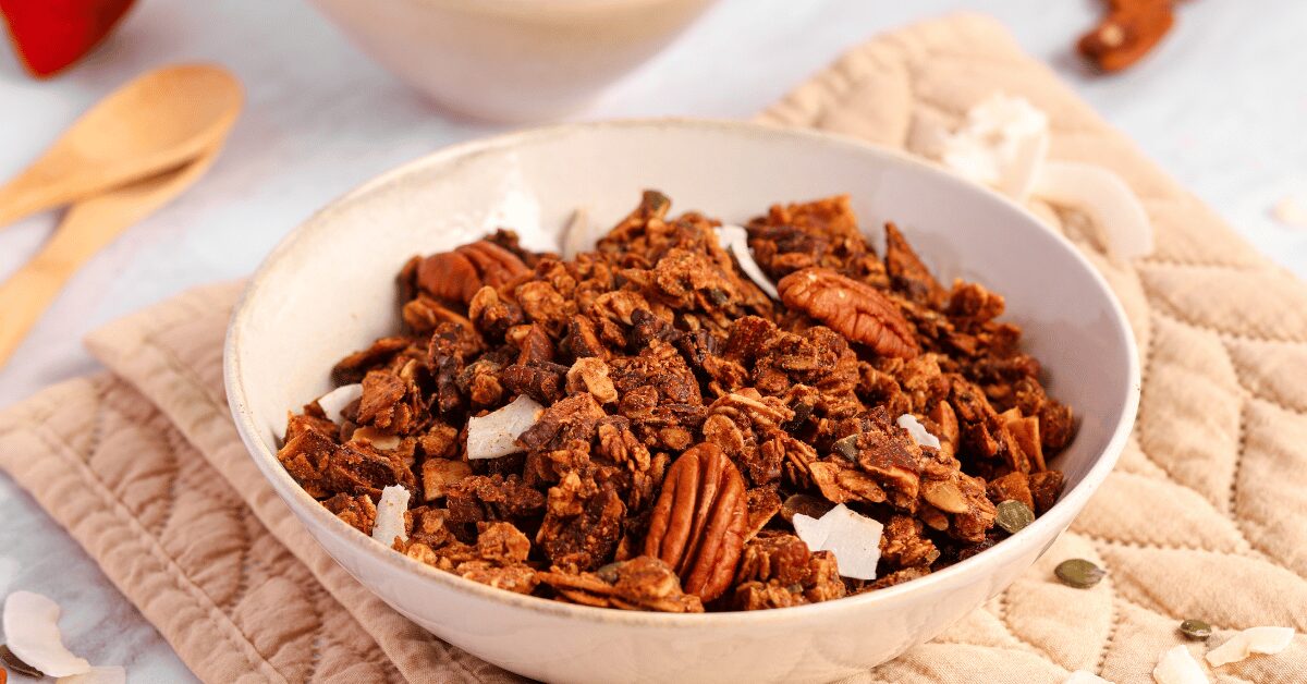 Bowl of golden almond and pecan granola with coconut chips and pumpkin seeds